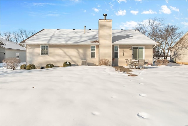 view of snow covered rear of property