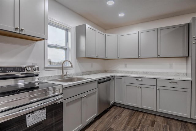 kitchen with stainless steel appliances, gray cabinets, and sink