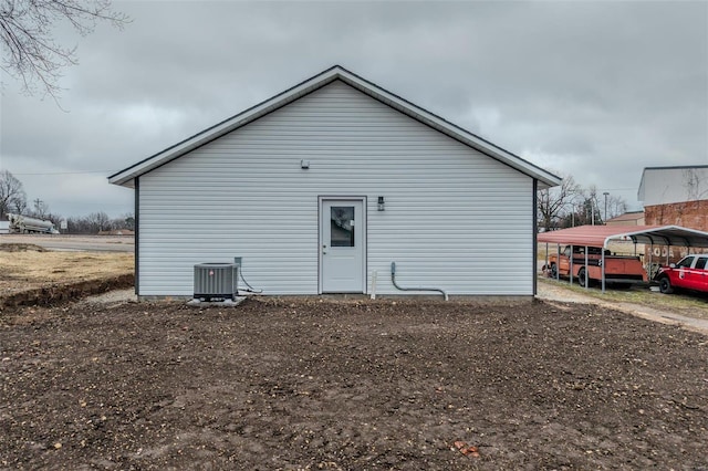 view of side of property featuring a carport and central air condition unit