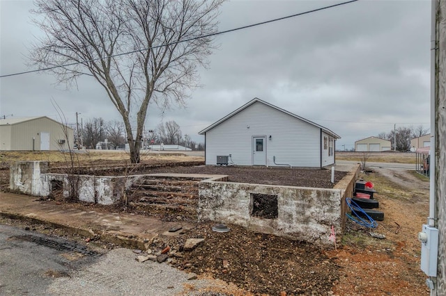 view of side of home with central AC unit