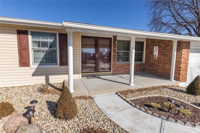 view of exterior entry featuring french doors