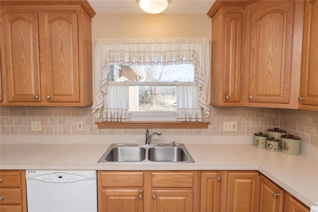 kitchen with sink, backsplash, and white dishwasher