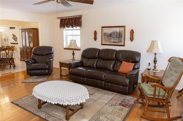 living room with ceiling fan and light hardwood / wood-style floors