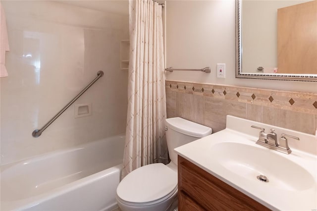 full bathroom featuring vanity, tile walls, shower / bath combination with curtain, and toilet