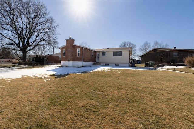 rear view of property with a lawn