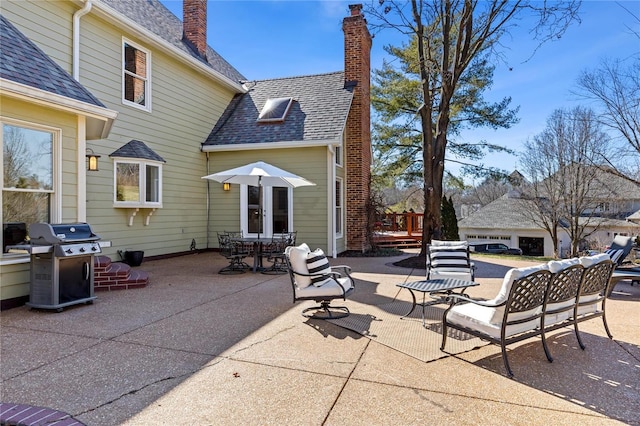 view of patio with french doors and a grill