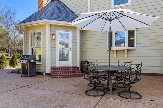 view of patio / terrace featuring entry steps, outdoor dining space, and grilling area