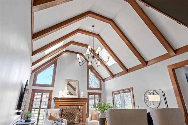 living area with high vaulted ceiling, a brick fireplace, a notable chandelier, and beamed ceiling