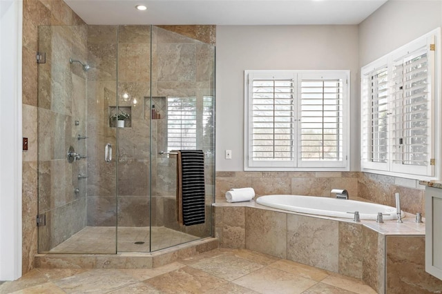 full bathroom featuring a garden tub and a shower stall