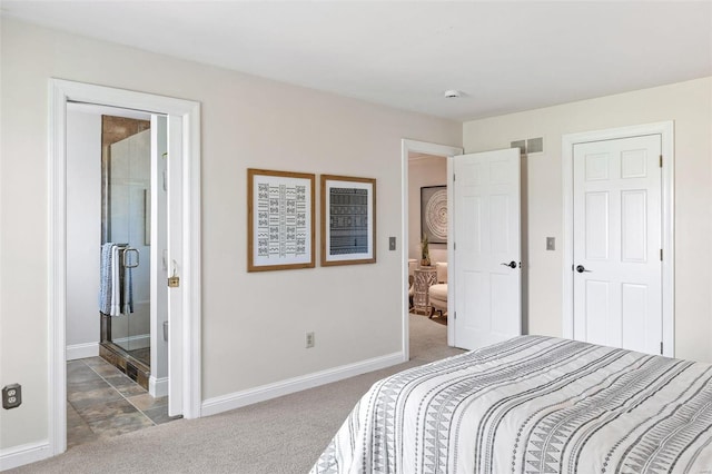 carpeted bedroom with baseboards, visible vents, and ensuite bathroom