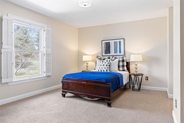 bedroom with carpet floors, multiple windows, and baseboards