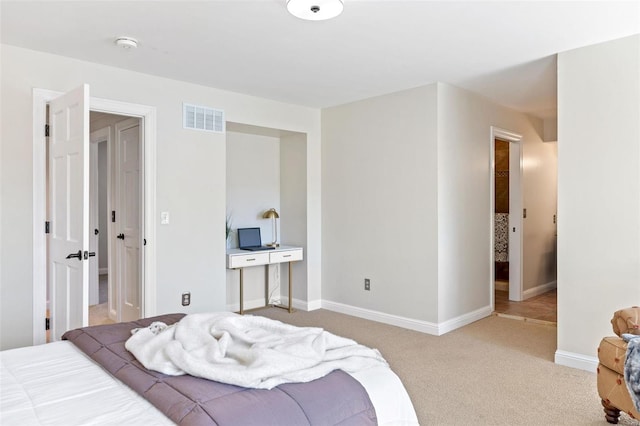 carpeted bedroom featuring visible vents and baseboards