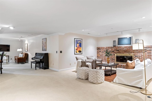 carpeted living area with a fireplace, recessed lighting, rail lighting, ornamental molding, and baseboards