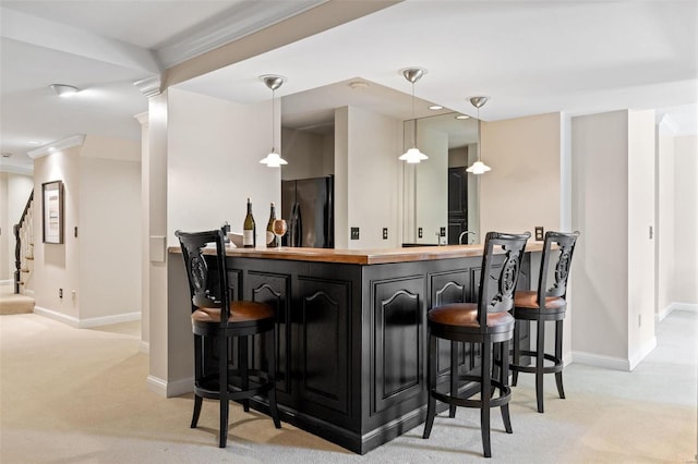 bar with freestanding refrigerator, bar, light carpet, and stairway