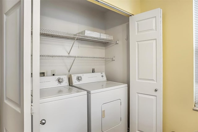 washroom featuring washing machine and dryer and laundry area