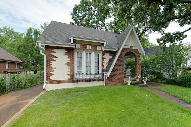 tudor house featuring a front yard