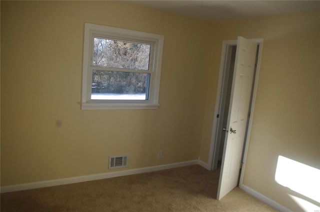 empty room featuring light colored carpet