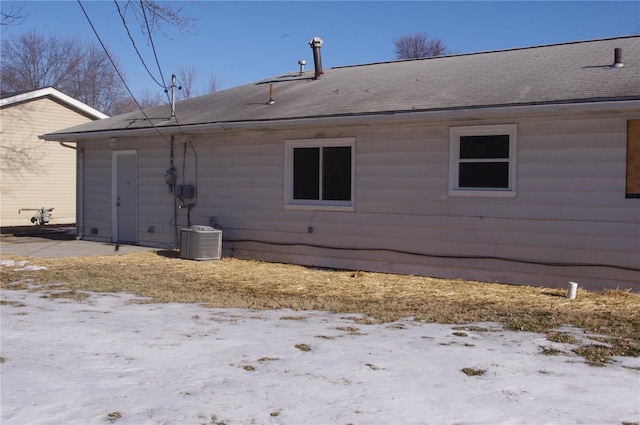 view of snowy exterior with central AC