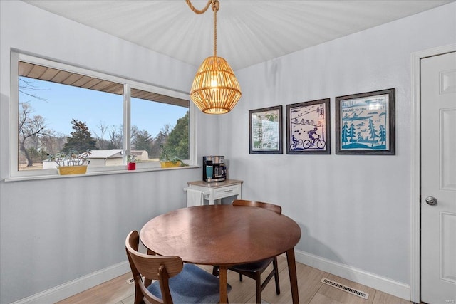 dining space featuring light wood-type flooring