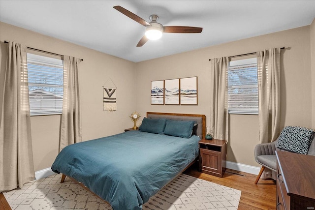 bedroom with light hardwood / wood-style floors and ceiling fan