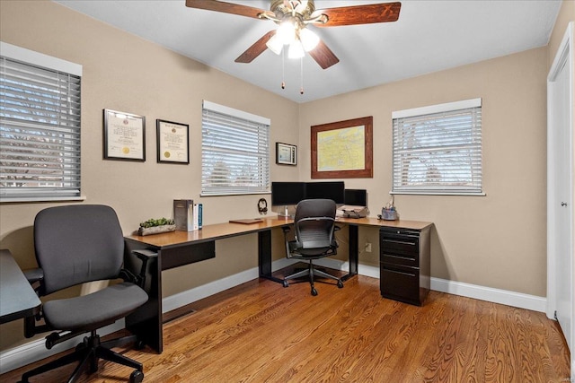 office area featuring plenty of natural light, ceiling fan, and light hardwood / wood-style flooring