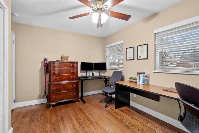 office with wood-type flooring and ceiling fan