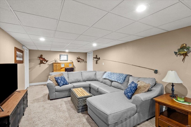 living room featuring light colored carpet and a drop ceiling