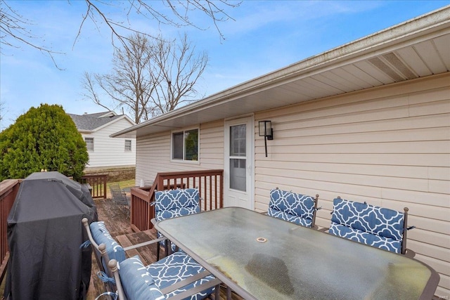 wooden deck with a grill