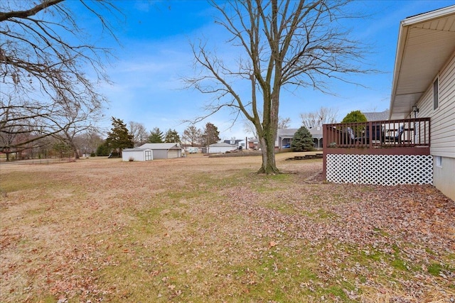 view of yard featuring a shed and a wooden deck