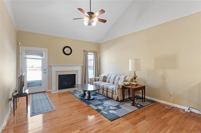 living room with high vaulted ceiling, light hardwood / wood-style floors, and ceiling fan