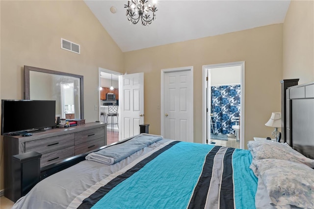 bedroom featuring an inviting chandelier, connected bathroom, and high vaulted ceiling