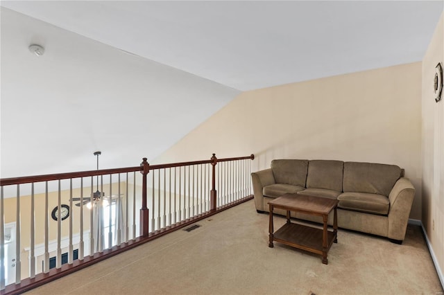 interior space with lofted ceiling, ceiling fan, carpet, and visible vents