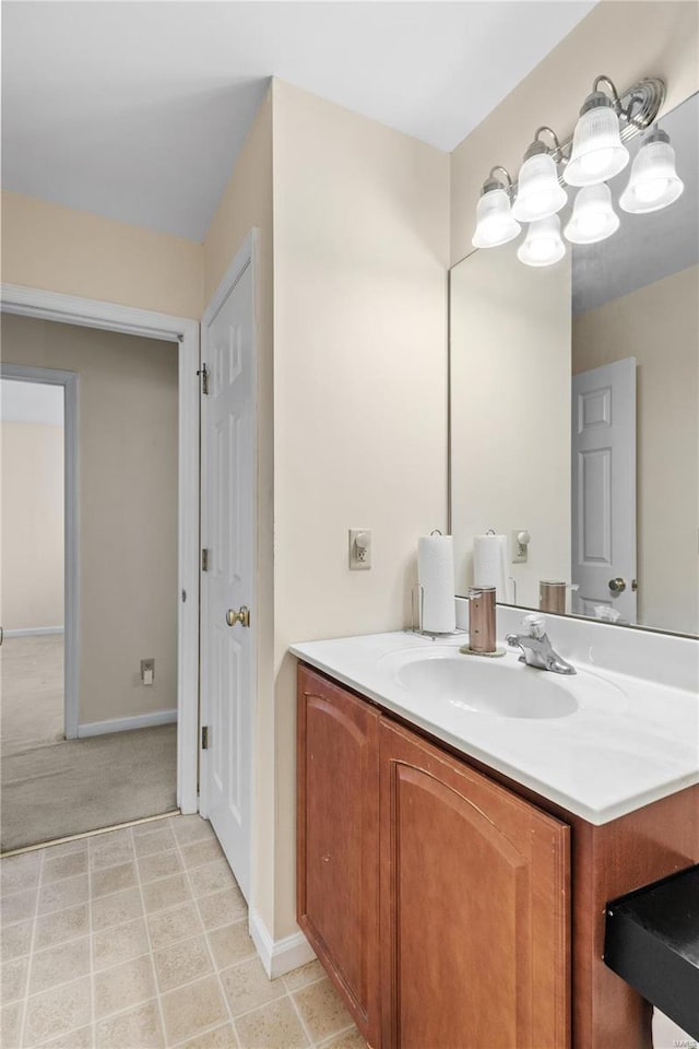 bathroom with vanity and baseboards