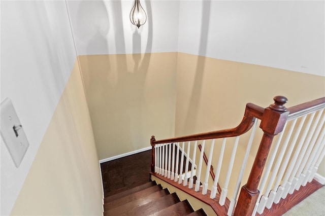 staircase featuring baseboards