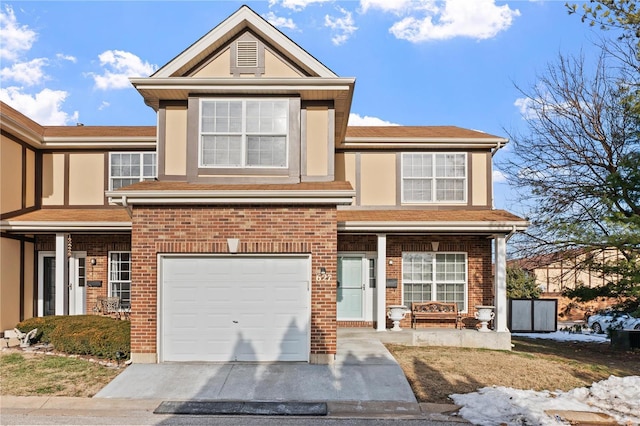 view of front facade with an attached garage, stucco siding, driveway, and brick siding