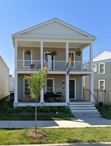 view of front of property with a porch and a balcony