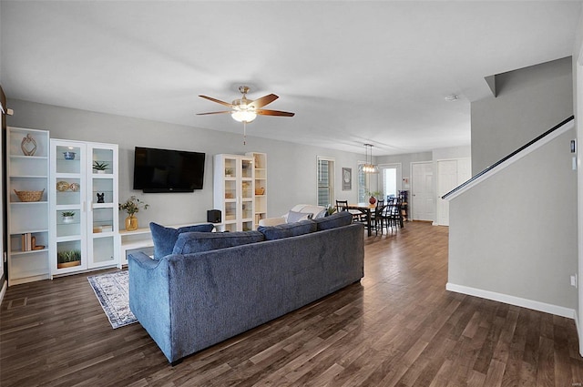 living room with dark wood-type flooring and ceiling fan