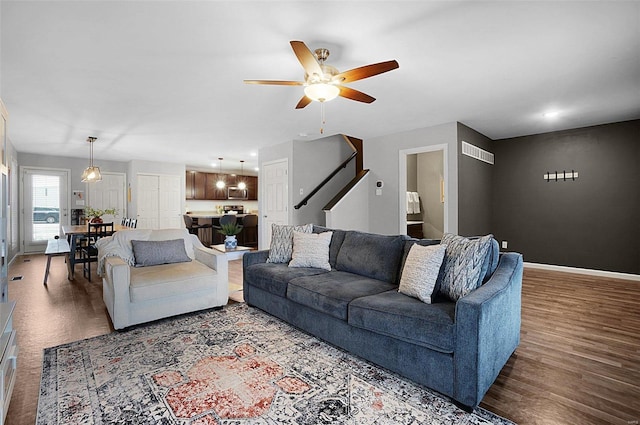 living room featuring hardwood / wood-style flooring and ceiling fan