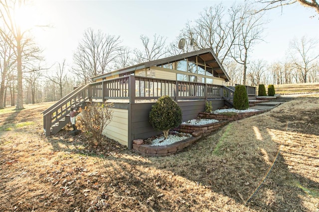 view of side of property featuring a wooden deck