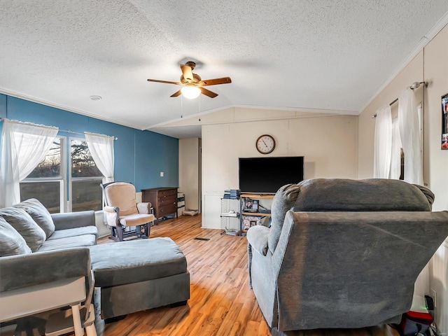 living room with hardwood / wood-style flooring, vaulted ceiling, a textured ceiling, and ceiling fan