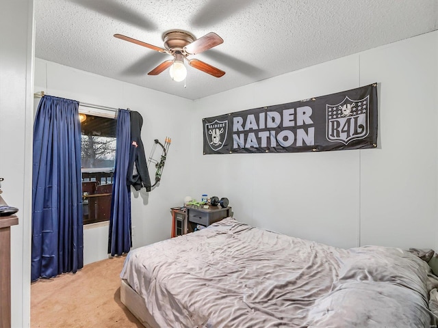 bedroom featuring ceiling fan, carpet flooring, and a textured ceiling