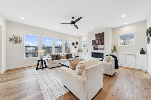 living room featuring recessed lighting, light wood-type flooring, and ceiling fan