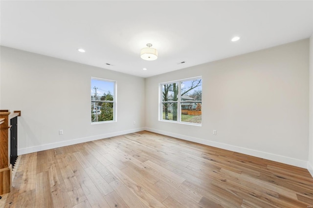 unfurnished living room featuring light wood-type flooring, baseboards, plenty of natural light, and recessed lighting