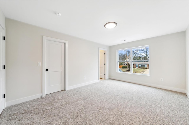 unfurnished bedroom with carpet flooring and baseboards