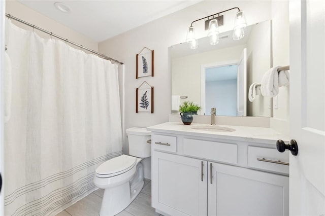 full bathroom featuring tile patterned flooring, vanity, and toilet