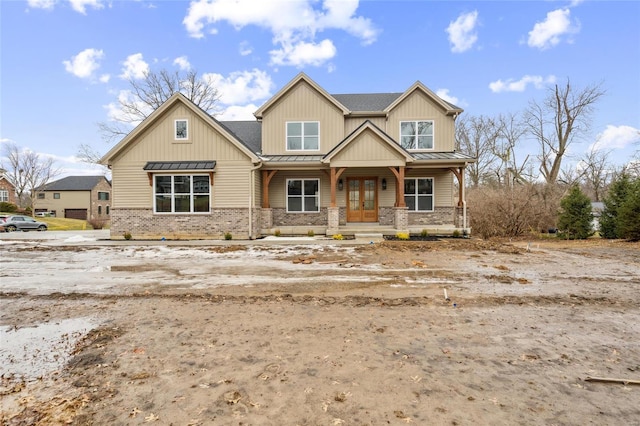 craftsman inspired home with a standing seam roof, a porch, metal roof, and french doors