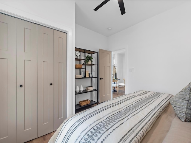 bedroom featuring light hardwood / wood-style floors, a closet, and ceiling fan