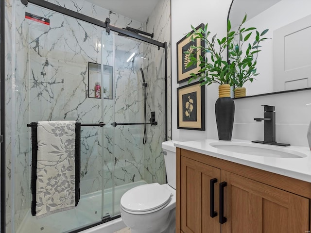 bathroom with vanity, toilet, and an enclosed shower
