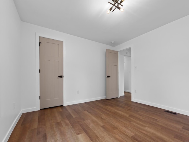 unfurnished room with wood-type flooring