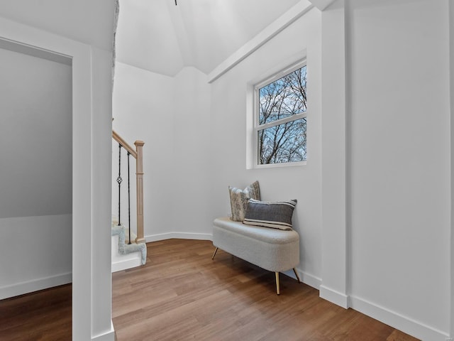 living area featuring vaulted ceiling and light wood-type flooring